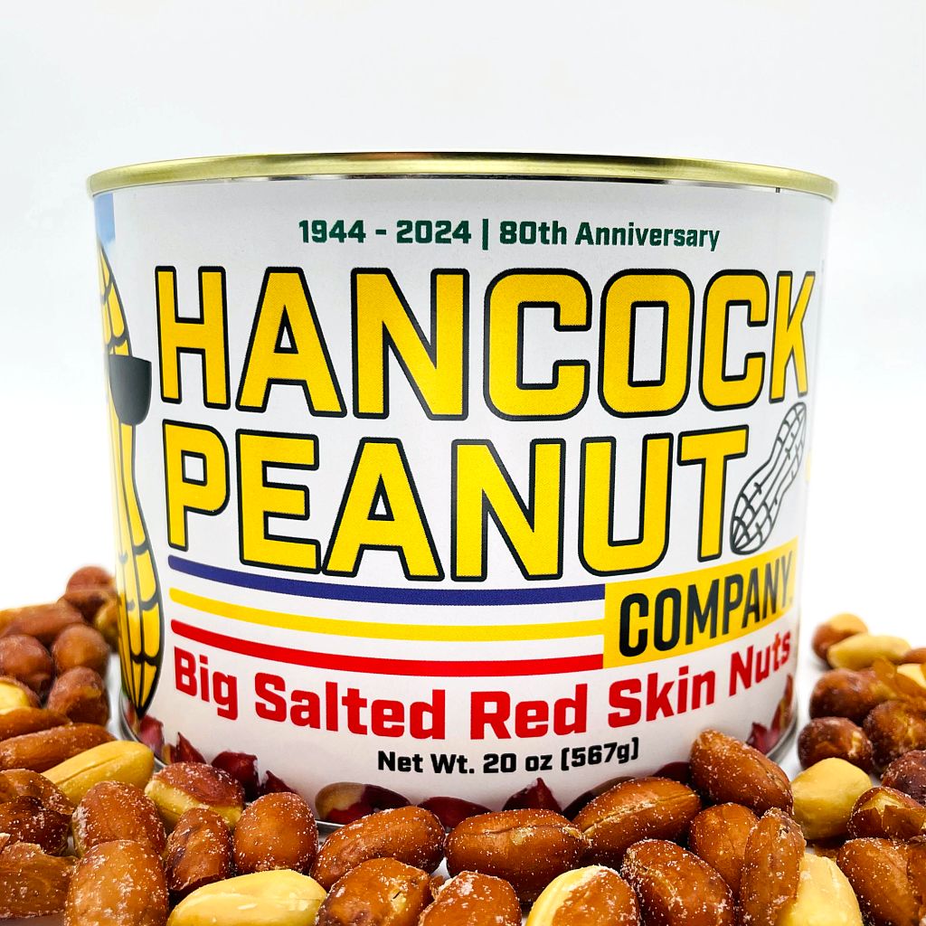 A can labeled Amazon 1 - Red Skin, Net Wt. 20 oz (567g), 1944-2024 | 80th Anniversary, is surrounded by salted red skin peanuts against a white background.