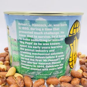 A can of Hancock Peanut Company Red Skin Peanuts sits among shelled and unshelled peanuts, its label highlighting Robert L. Hancock, Jr.'s legacy in the peanut industry.