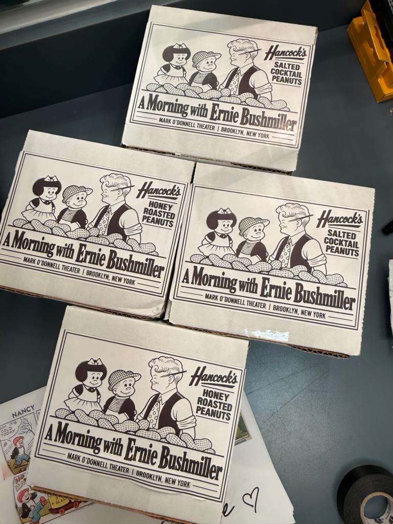 Four cardboard boxes of Hancocks peanuts labeled 857743111_1119670501004222_6998490775798644544_n, each featuring a cartoon illustration of characters from the Nancy comic strip and the text A Morning with Ernie Bushmiller.